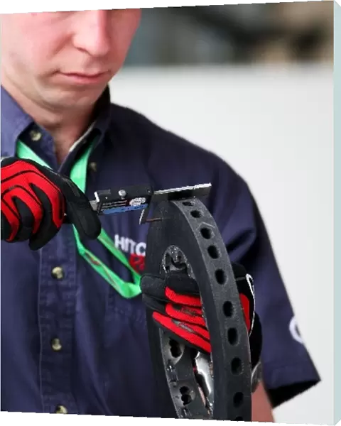 Formula One World Championship: Mechanic works on Brake disk