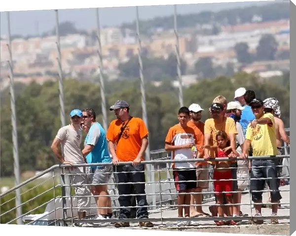 Formula One Testing: Fans watch the action with Jerez town in the background