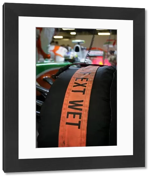 Formula One World Championship: Wet tyres are put on the car of Giancarlo Fisichella Force India F1 before the race