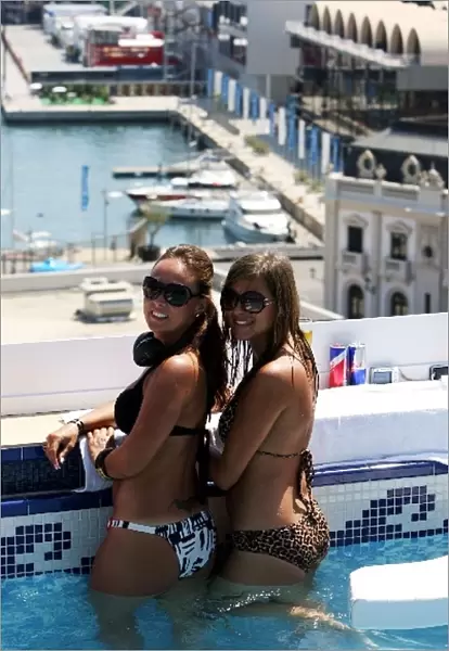 Formula One World Championship: Monika and Natalia watch the action from the Red Bull roof top race day pool party