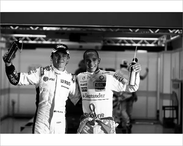Formula One World Championship: third placed Nico Rosberg Williams and pole sitter Lewis Hamilton McLaren in parc ferme