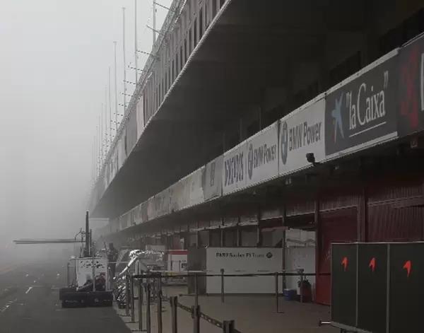 Formula One Testing: Red lights at the end of the pitlane. Start of testing delayed due to fog