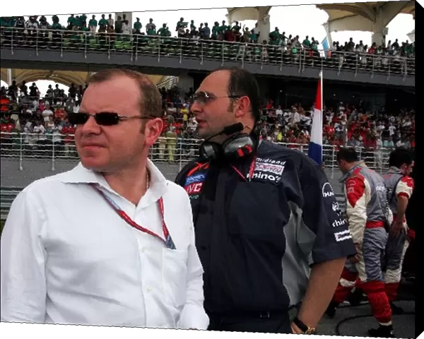 Formula One World Championship: Alex Shnaider and Dr Colin Kolles MF1Team Manager on the grid