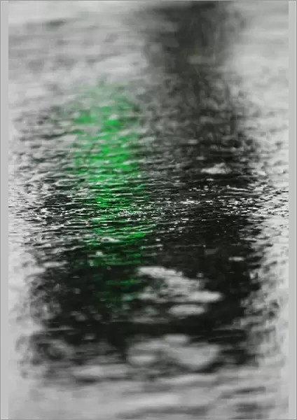 Formula One Testing: A green light reflected in the flooded pitlane