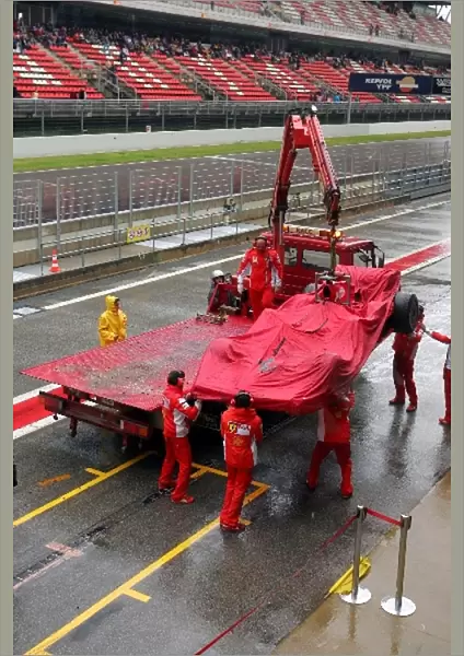 Formula One Testing: The car of Kimi Raikkonen Ferrari F2007 returns to the pits on a truck after a spin into the gravel in the wet conditions