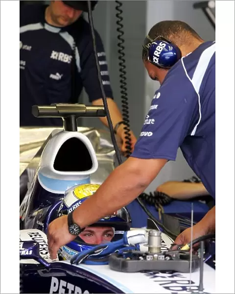 Formula One Testing: Mechanics install the headrest for Nico Rosberg Williams FW29