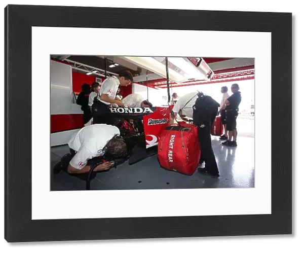 Formula One Testing: Mechanics start the car of Takuma Sato Super Aguri F1 Team SA07 in the garage