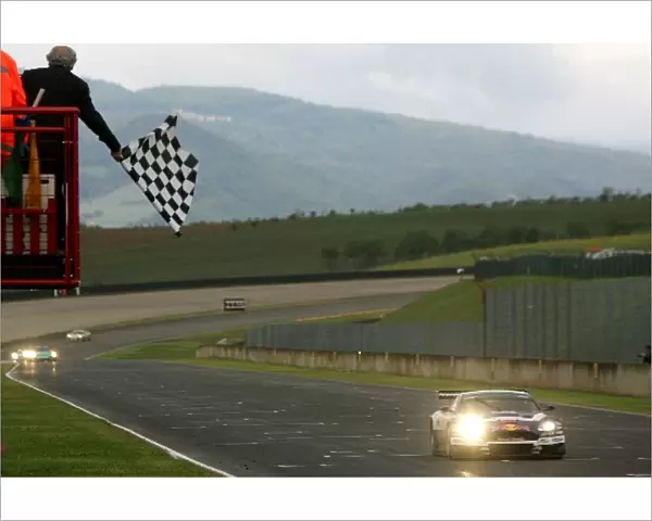 FIA GT Championship: Race winner Karl Wendlinger Race Alliance Aston Martin DBR9, crosses the line