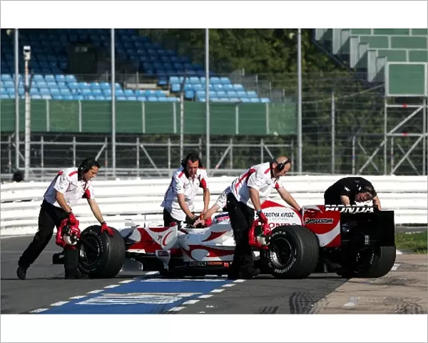 F1 Testing: Takuma Sato Super Aguri SA06 is pushed back into the garage