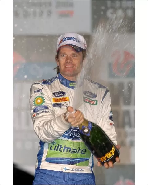 FIA World Rally Championship: Marcus Gronholm sprays the winners champagne on the podium in Cardiff
