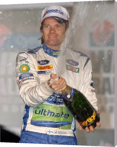 FIA World Rally Championship: Marcus Gronholm sprays the winners champagne on the podium in Cardiff