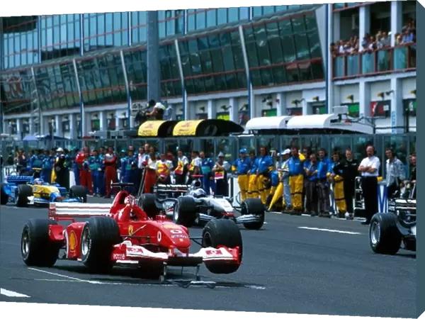 Formula One World Championship: The Ferrari F2002 of Rubens Barrichello was left stranded on its front jacks at the start of the parade lap