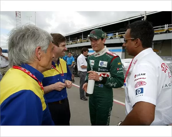 Formula One World Championship: A happy Mark Webber Jaguar meets with Pierre Dupasquier Michelin Director of Worldwide Racing and Nav Sidhu Jaguar
