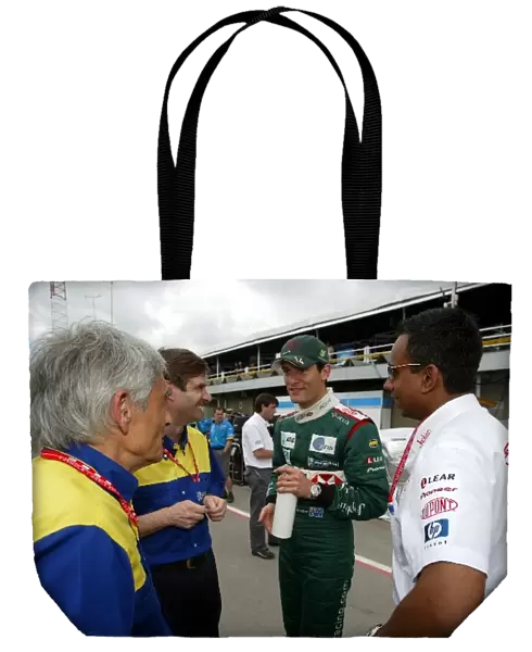 Formula One World Championship: A happy Mark Webber Jaguar meets with Pierre Dupasquier Michelin Director of Worldwide Racing and Nav Sidhu Jaguar