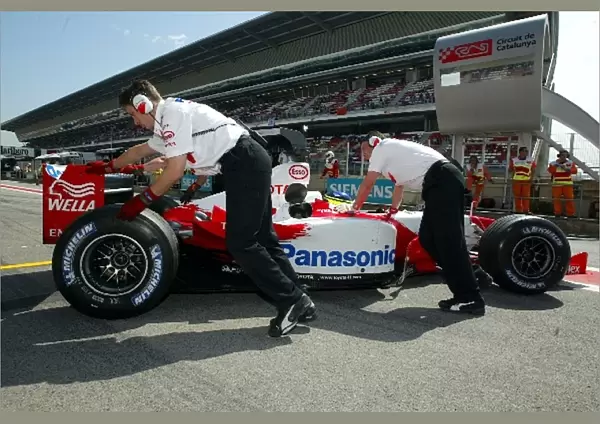 Formula One World Championship: The Toyota team push Cristiano Da Matta Toyota TF103 into the garage