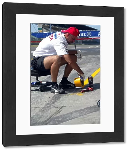 Formula One World Championship: A Toyota mechanic sets up the pit box in the pitlane