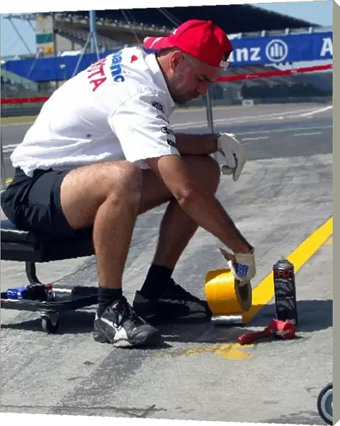 Formula One World Championship: A Toyota mechanic sets up the pit box in the pitlane