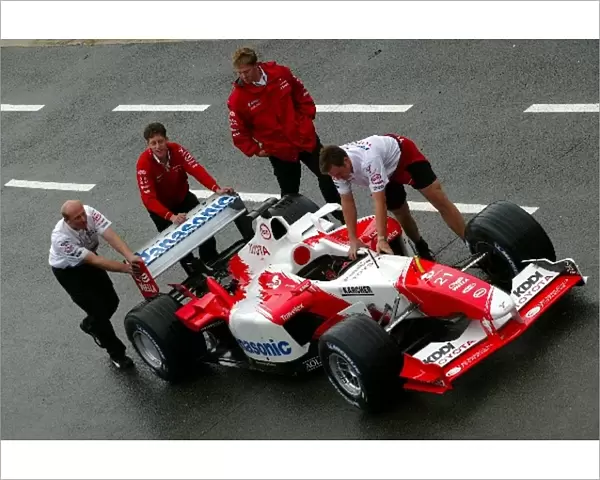 Formula One World Championship: A Toyota TF103 is pushed down the pitlane