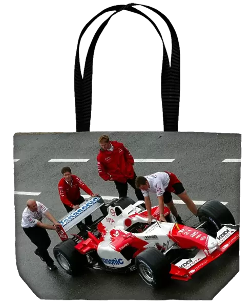 Formula One World Championship: A Toyota TF103 is pushed down the pitlane