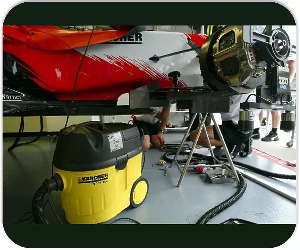 Formula One World Championship: Toyota mechanics use a Karcher vacuum cleaner
