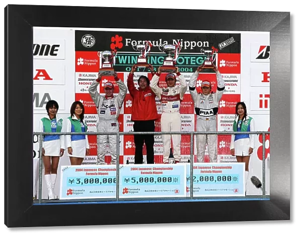 2004 Formula Nippon Championship Rd 8. Motegi, Japan. 24th October 2004. Winner Yuji Ide celebrates on the podium with a mobilecast IMPUL team member, second placed Ricahrd Lyons and thrid placed Andre Lotterer