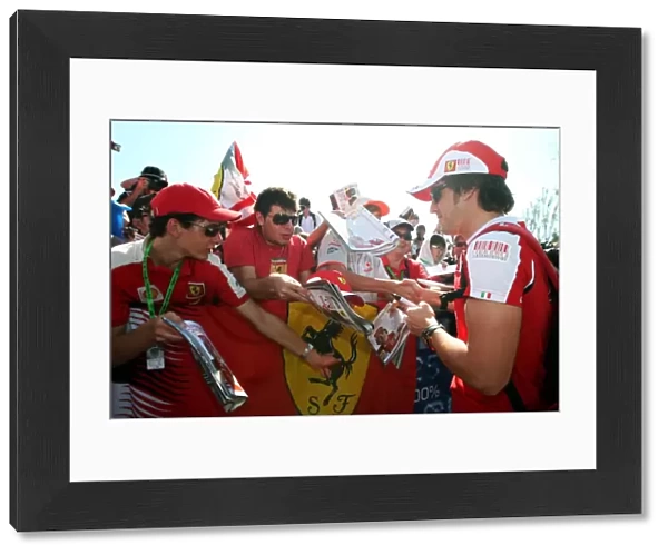 Formula One World Championship: Fernando Alonso Ferrari signs autographs for the fans