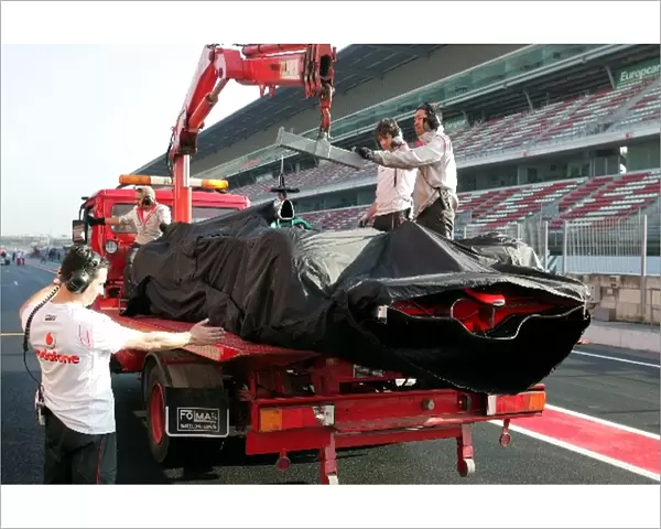 Formula One Testing: The car of Heikki Kovalainen McLaren Mercedes MP4  /  23 is recovered after breaking down on track