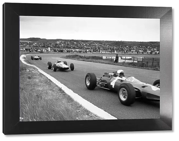 1965 Dutch Grand Prix. Zandvoort, Holland. 18 July 1965. Lorenzo Bandini, Ferrari 158, 9th position, leads Mike Spence, Lotus 25-Climax, 8th position, action. World Copyright: LAT Photographic Ref: Motor b&w print