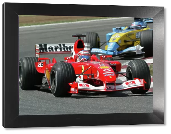 2003 Spanish Grand Prix - Sunday Race, Barcelona, Spain. 4th May 2003. Rubens Barrichello, Ferrari F2003 GA, leads Fernando Alonso, Renault R23, action. World Copyright LAT Photographic. ref: Digital Image Only