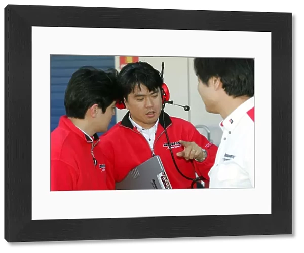 Formula One Testing: Bridgestone technicians chat in the pitlane