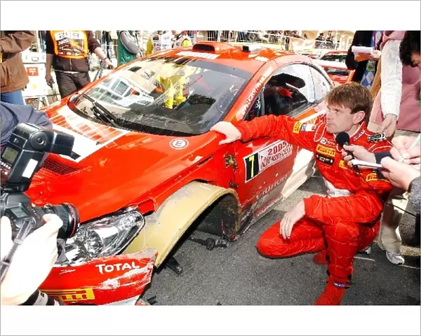 FIA World Rally Championship: Marcus Gronholm looks at the damage to his Peugeot 307 WRC at the in control for service