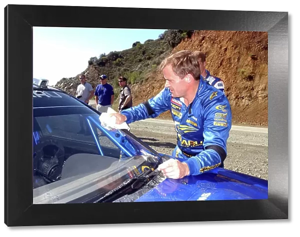 World Rally Championship, Cyprus Rally, April 18-21, 2002. Tommi Makinen cleans the windscreen on his Subaru Impreza WRC 2002 before the first of the final day's stages. Photo: Ralph Hardwick / LAT