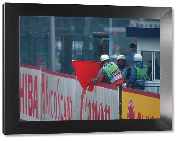 1994 Japanese Grand Prix. Suzuka, Japan. 6-8 November 1994. A marshall hangs out the red flag as the Grand Prix is stopped due to the accidents of Herbert