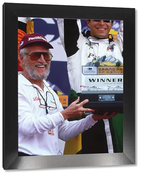 2003 Champ Car Denver Priority 2003 Champ Car World Series. 29-31 August 2003 Centrix Financial Grand Prix of Denver. Denver, Colorado. Newman / Haas team co-owner and actor Paul Newman celebrates on the podium with Bruno Junqueira