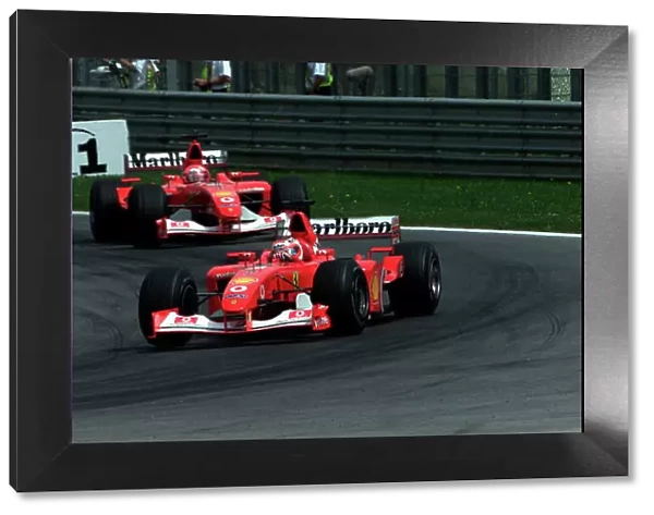 2002 Austrian Grand Prix A1-Ring, Austria, 10th-12th May 2002 Rubens Barrichello, Ferrari F2002, leads Michael Schumacher, Ferrari F2002, World Copyright Photo4