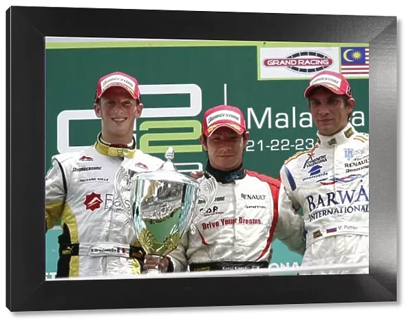 2008 GP2 Asia Series. Round 3. Sunday Race. Sepang, Kuala Lumpur. Malaysia. 23rd March. Kamui Kobayashi (JPN, Dams) celebrates his victory on the podium with Romain Grosjean (FRA, ART Grand Prix) and Vitaly Petrov (RUS)