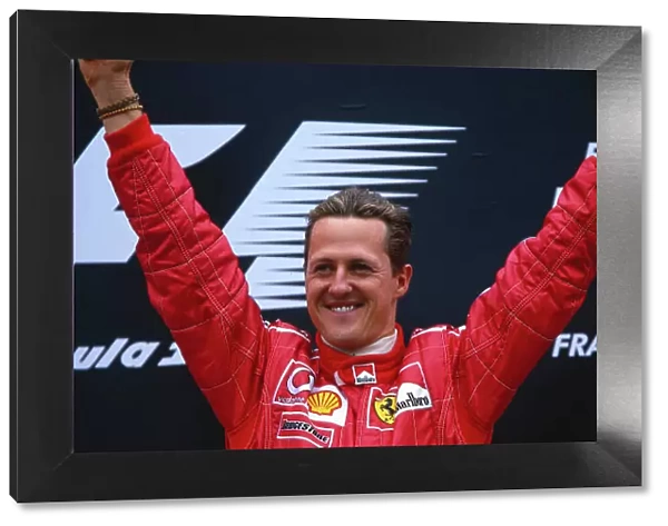2002 Belgian Grand Prix. Spa-Francorchamps, Belgium. 30 / 8-1 / 9 2002. Michael Schumacher (Ferrari) celebrates his 1st position and record 10th Grand Prix win in a single season, on the podium. Ref-02 BEL 23. World Copyright - Rose / LAT Photographic
