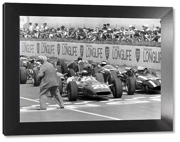1966 French Grand Prix. Reims, France. 3 July 1966. Lorenzo Bandini, Ferrari 312, not classified, and John Surtees, Cooper T81-Maserati, retired, on the front row before the start, action. World Copyright: LAT Photographic Ref: Motor b&w print