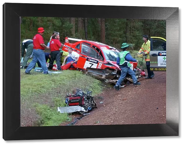 2002 World Rally Championship. Telstra Rally Australia, Perth. October 31st-November 3rd. Richard Burns helps out at the crash scene of Francois Delecour's massive accident which ripped out the engine and transmission assembly. Photo