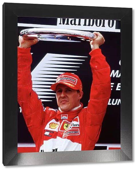 2001 Spanish Grand Prix Barcelona, Spain. 27th - 29th April 2001. Michael Schumacher Holds his trophy above his head after his third win this season World Copyright: LAT Photographic ref: 35mm Image