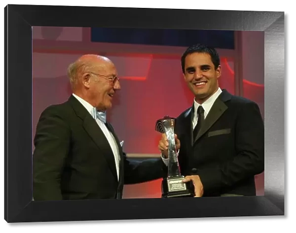 2003 AUTOSPORT AWARDS, The Grosvenor, London. 7th December 2003. Juan Pablo Montoya accepts the Trophy for International driver from Stirling Moss. Photo: Peter Spinney / LAT Photographic Ref: Digital Image only