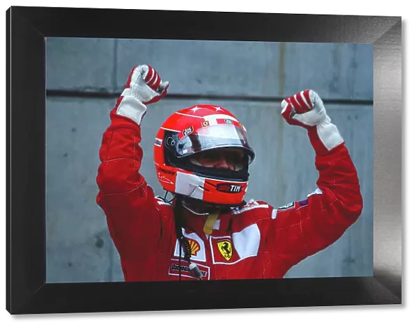 2000 United States Grand Prix. Indianapolis, Indiana, USA. 22-24 September 2000. Michael Schumacher (Ferrari) celebrates his 1st position in parc ferme. Ref-2K USA 53. World Copyright - LAT Photographic