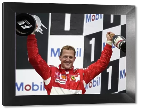 2006 German Grand Prix - Sunday Race Hockenheim, Germany. 27th - 30th July. Michael Schumacher (1st position), Ferrari, celebrates on the podium. World Copyright: Charles Coates / LAT Photographic ref: Digital Image ZK5Y2479
