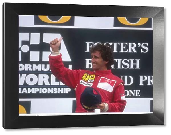 1990 British Grand Prix. Silverstone, England. 13-15 July 1990. Alain Prost (Ferrari) celebrates his 1st position on the podium. Ref-90 GB 05. World Copyright - LAT Photographic