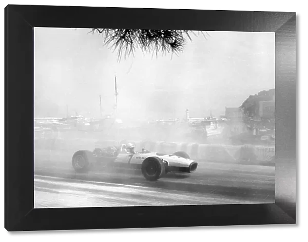 1967 Monaco Grand Prix. Monte Carlo, Monaco. 7 May 1967. John Surtees, Honda RA273, retired, through the smoke caused by Bandini's accident, action. World Copyright: LAT Photographic Ref: Autosport b&w print