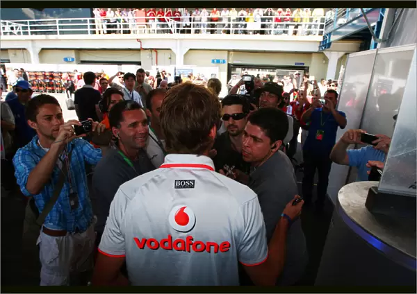 Formula One World Championship: A media scrum follows Jenson Button McLaren the morning after he was subjected to an attempted armed car attack