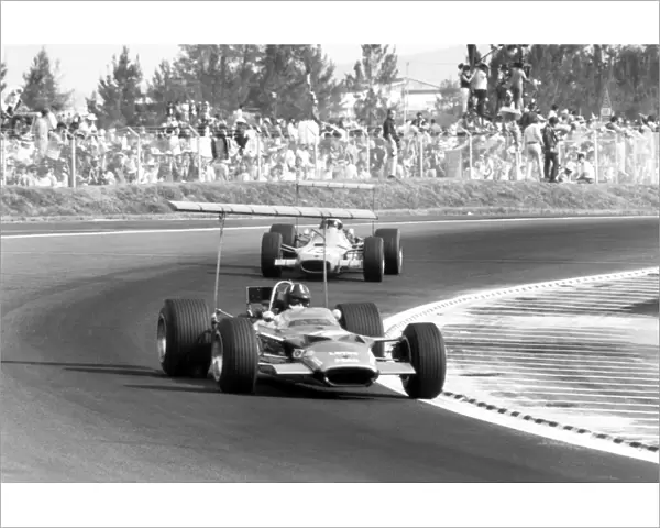 1968 Mexican Grand Prix - Graham Hill and Jackie Stewart: Graham Hill, Lotus 49B-Ford, 1st position, leads Jackie Stewart, Matra MS10-Ford, 7th position