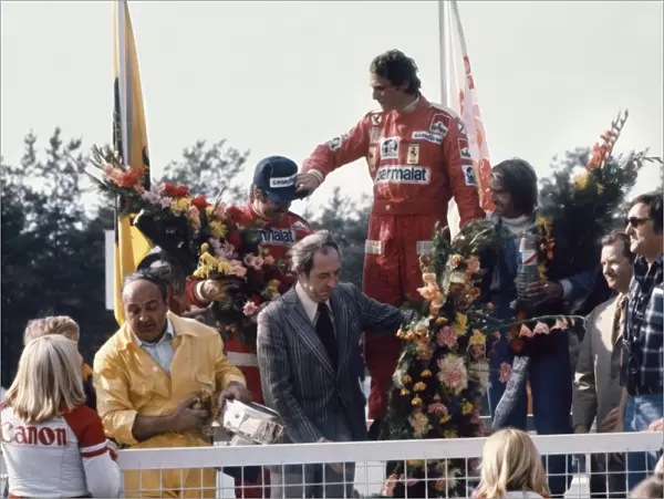 1976 Belgian Grand Prix - Podium: Niki Lauda, 1st position, celebrates with Clay Regazzoni, 2nd position and Jacques Laffite, 3rd position on the podium