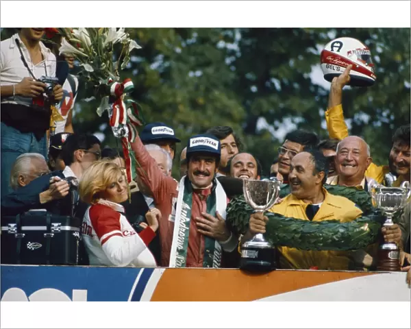 1975 Italian Grand Prix - Podium: Clay Regazzoni, 1st position, celebrates on the podium, portrait