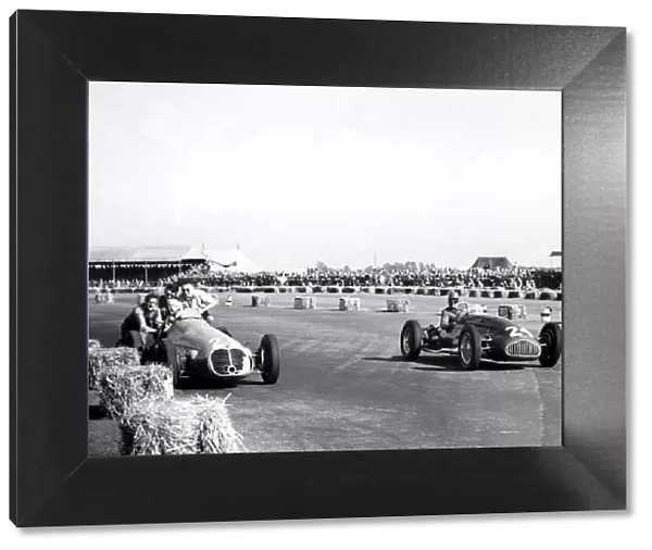1950 British Grand Prix - Geoffrey Crossley and B. Bira: Geoffrey Crossley passes the retiring B. Bira'